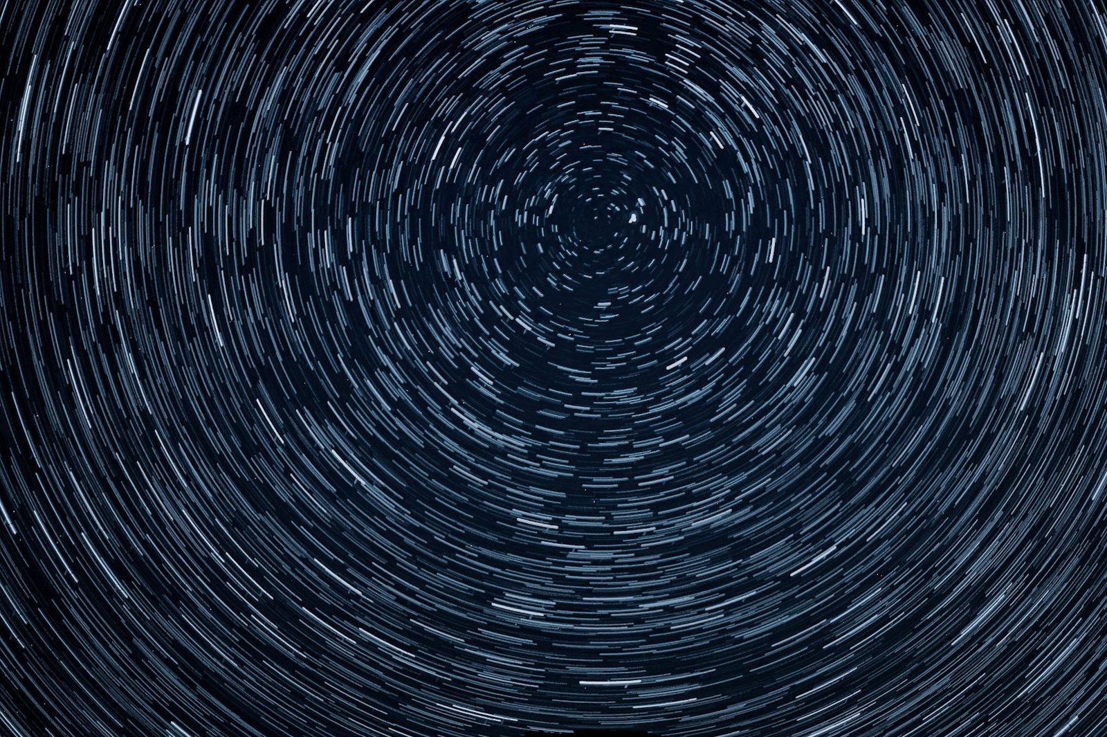 Opening frame of THE NIGHT SKY — star trail / lunar / eclipse.